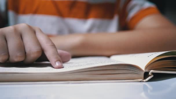 Child Runs Finger along Page of Book and Reads Quickly. Reading Remotely at Home — Stock Video