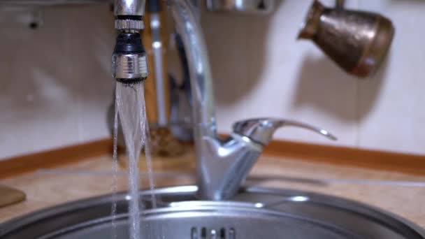 Water from An Open Nickel-Plated Faucet Flows into Sink in a Modern Kitchen — Stock Video