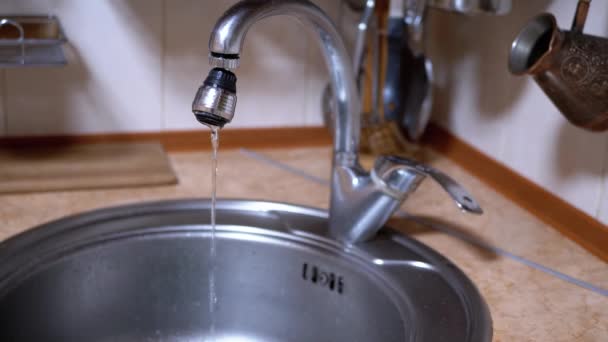 Water from An Open Nickel-Plated Faucet Flows into Sink in a Modern Kitchen — Stock Video