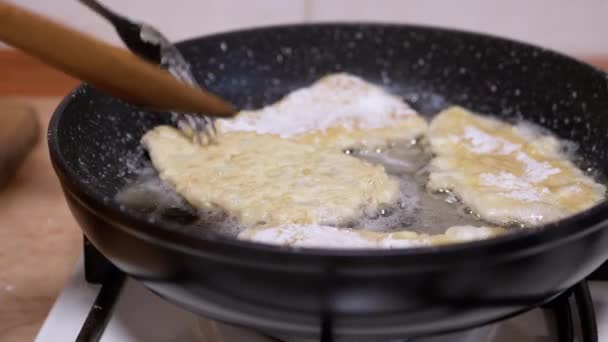 Samice ručně otočí kuřecí kotlety na pánvi s dřevěnou patulou. Cook Meat — Stock video