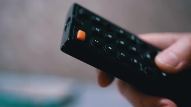 Female Fingers Switch TV Channels With Black Remote Control. Close-up. — Stock Video