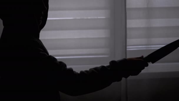 Silhouette of Lonely Child in Hood with Knife in Hand near Window. Killer Teen — Stock Video