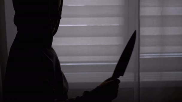 Silhouette of Lonely Child in Hood with Knife in Hand near Window. Killer Teen — Stock Video