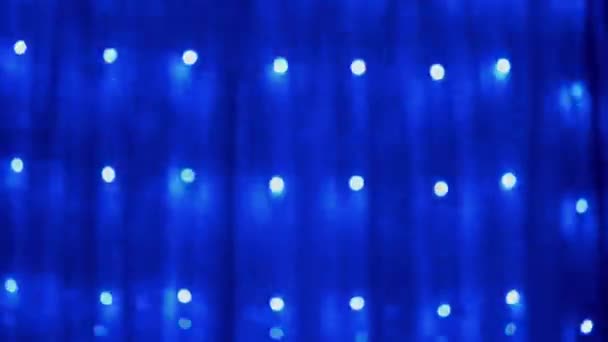 Christmas Garland of Many Blinking, Flickering Blue LED Lights on Curtain (dalam bahasa Inggris). 4K — Stok Video