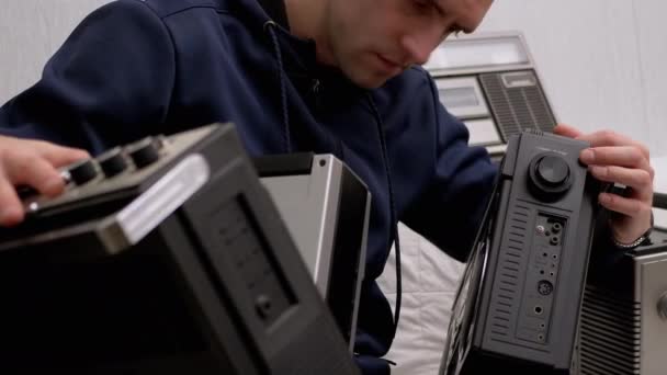 Contented Male-Collector Holds Three Vintage Audio Cassette Recorders in Hands — Stock Video