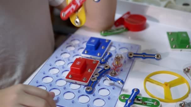 Curious Boy Plays with an Electrical Metal Constructor on Table at Home. 180fps — Stock Video