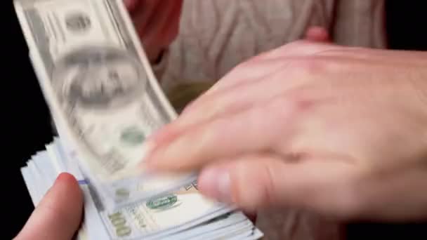 Male Hands Scatter Stack of 100 US Dollar Bills on Black Background. Money. 4K — Stock Video