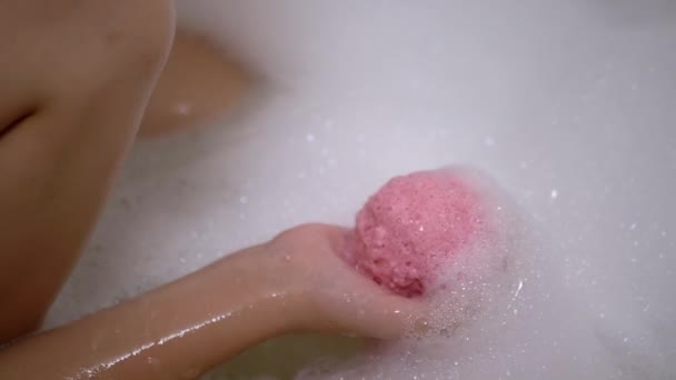 Ball of Bathroom Salt Dissolves in Foam Water, in Hands Child. Slow-motion. — Stock Video