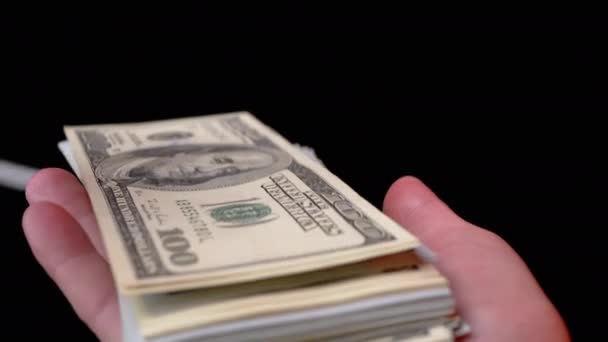 Male Hands Scatter Stack of 100 US Dollar Bills on Black Background (em inglês). Dinheiro. 4K — Vídeo de Stock