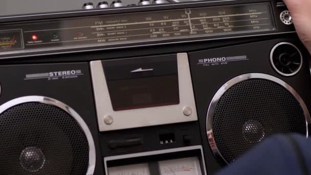 Male Holds Vintage Audio Tape Recorder in Hands with Rotating Audio Cassette — Stock Video