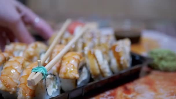 Japanese Sushi Rolls in Plastic Box a Served on Table with Bamboo Sticks, Wasabi — 비디오