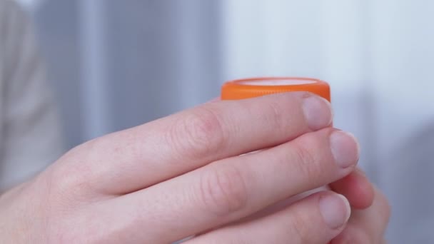 Woman Takes and Swallows Pills from a White Jar (en inglés). Muchas píldoras caen en la mano. 4K — Vídeo de stock
