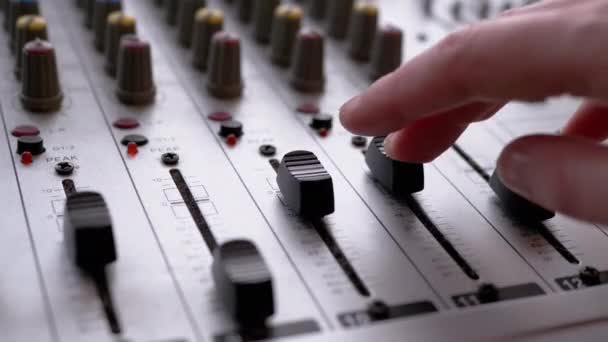 Sound Engineer, DJ Moves Sliders with Fingers on Audio Mixer in Recording Studio — Stock video