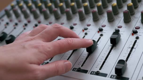 Sound Engineer, DJ Moves Sliders with Fingers on Audio Mixer in Recording Studio — Stock video