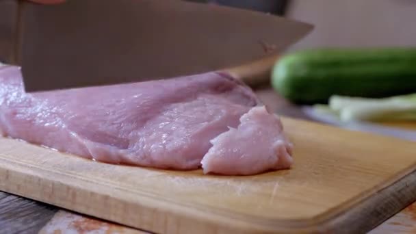 Female Hands Cuts Raw Pork Meat with a Sharp Knife on a Cutting Wood Board. 4K — Video