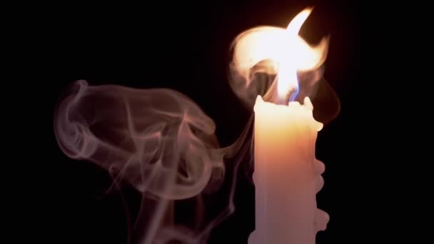 Weiße Kerze brennt in einer Rauchwolke auf schwarzem Hintergrund. Zeitlupe — Stockvideo