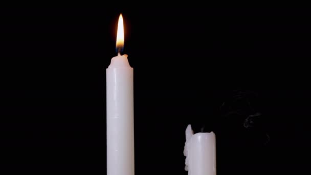 Two White Paraffin Candles are Blown Out by a Stream of Air on Black Background. — Stock Video