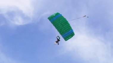 Paraşütçüler Mavi Gök 'te Paraglider' la Uçuyor ve Yeşil Çimen 'e İniyor. 4K