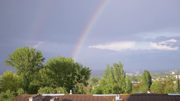 Erscheinen eines doppelt hellen Regenbogens am Horizont durch graue Wolken am Himmel. 4K — Stockvideo