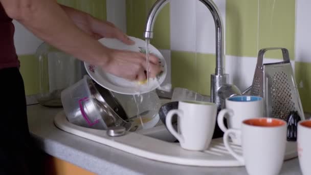 Male Hands Washes Dirty Plate with a Sponge in Kitchen Sink Under Running Water — Stock Video