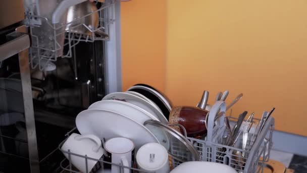 Human Puts Dirty Unwashed Dishes on the Shelves of a Dishwasher. Zoom — Stock Video