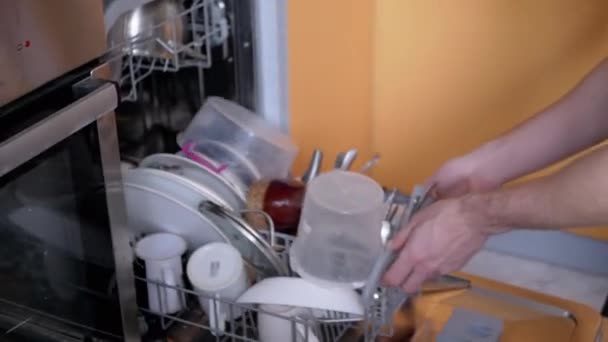 Human Puts Dirty Unwashed Dishes en los estantes de un lavavajillas. 4K — Vídeos de Stock