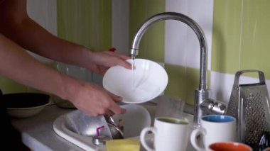 Male Hands Wash Dirty Plate, Dishes in Kitchen Sink Under Running Water