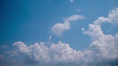 Hopeful time-lapse of clouds clearing, showing grey cloud cover dissipating to reveal fluffy white cumulus formations moving across vibrant, sunny blue sky, symbolizing optimism and clear weather.