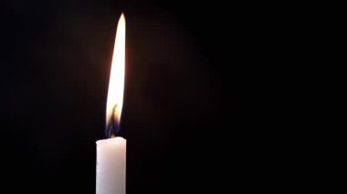 Burning Wax Candle in Cloud of Thick Smoke on Black Background. Puffs of thick smoke fill empty space with burning candle. Abstract, isolated. Blurred motion. Soft texture, structure of smoke or steam.