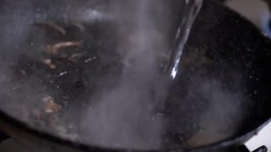 Bu, yağlı bir tavayı, kalıntıları düzgün kaldırmak için suyu kullanarak nasıl etkili bir şekilde temizleyeceğini gösteren detaylı bir dizi.