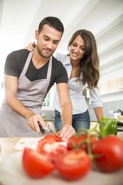 Young couple in kitchen prearing lunch