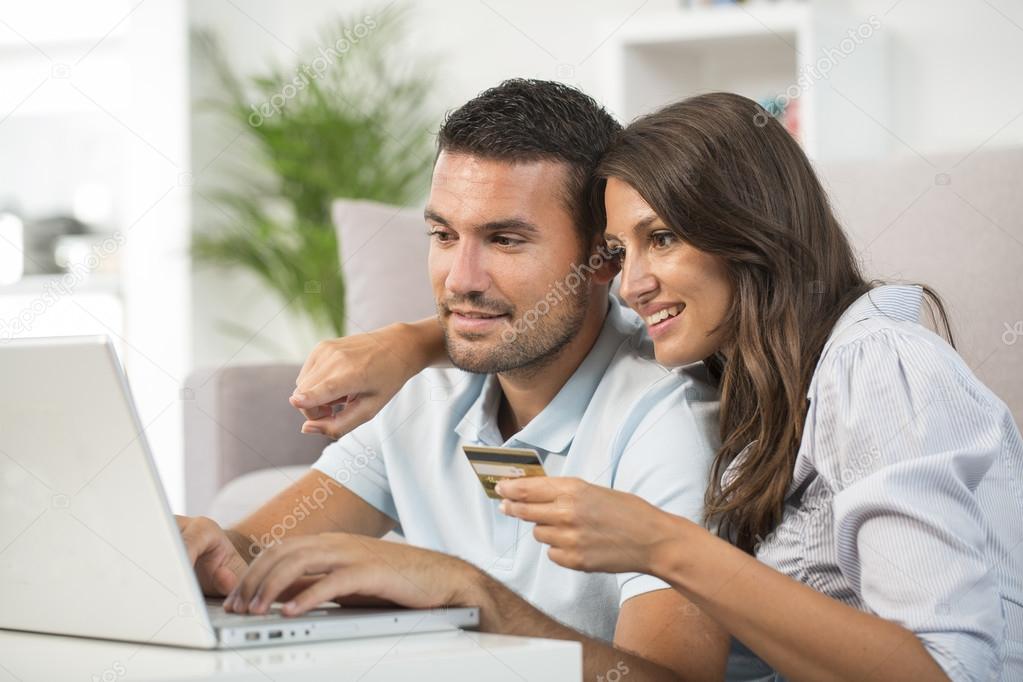 Couple using credit card to shop online