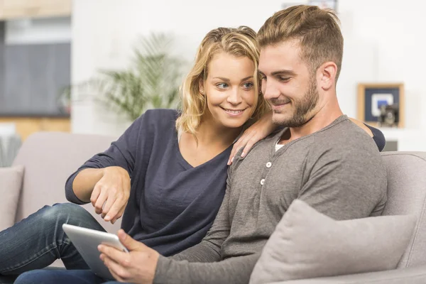 Young couple websurfing on internet with touchpad — Stock Photo, Image