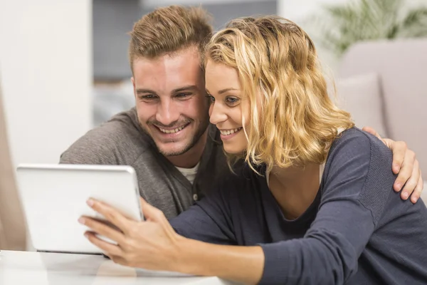 Young couple using touchpad — Stock Photo, Image