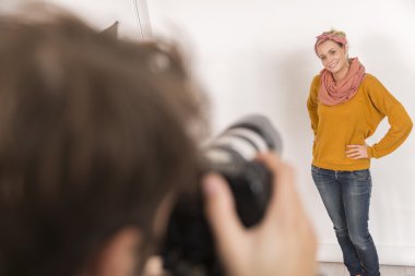 fashion photographer at work in studio clipart