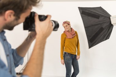 fashion photographer at work in studio clipart