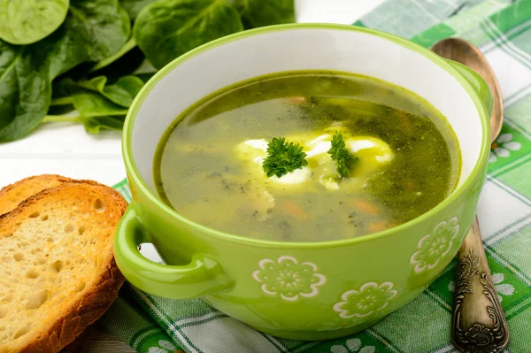 Vegetarian soup with vegetables as carrot, spinach, potatoes, parsley and mushrooms. — Stock Photo, Image