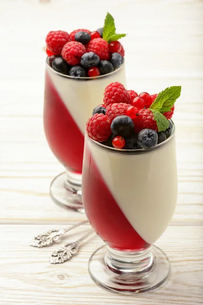 Delicious dessert - panna cotta with berry jelly and berries. — Stock Photo, Image