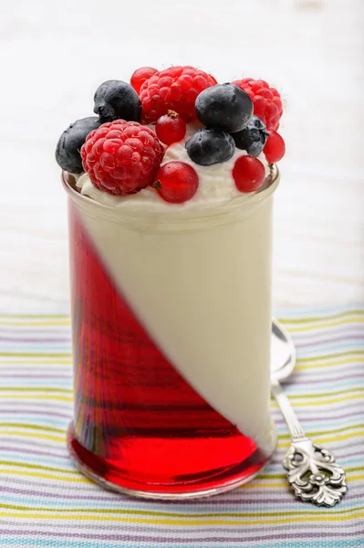 Delicious dessert - panna cotta with berry jelly and berries. — Stock Photo, Image