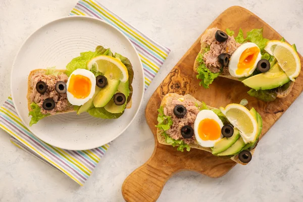 Tuna, eggs, olives  and avocado sandwiches