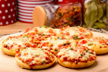 Ahşap tahta üzerinde mini pizza.