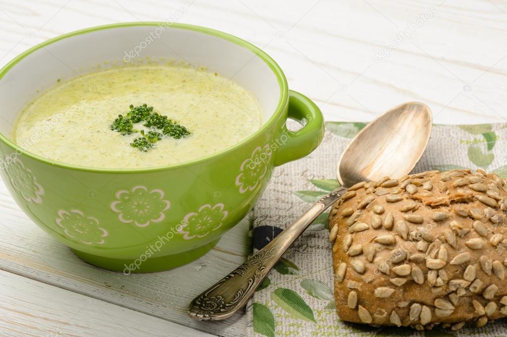 Broccoli cream soup on the wooden table.