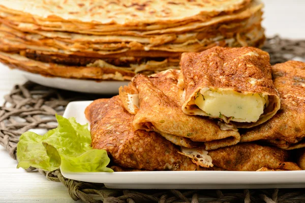 Stuffed pancakes on wooden background. — Stock Photo, Image