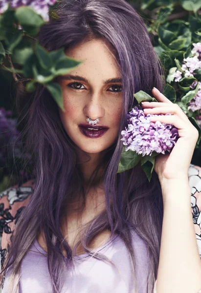 woman with purple hair and lilac flowers