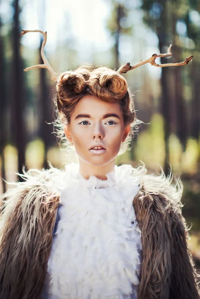 Woman with tree branches in hair — Stock Photo, Image