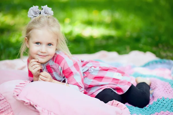 Girl lying on coverlet — Stock Photo, Image