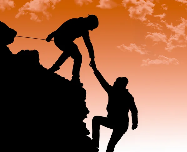 Silhouette of helping hand between two climber — Stock Photo, Image