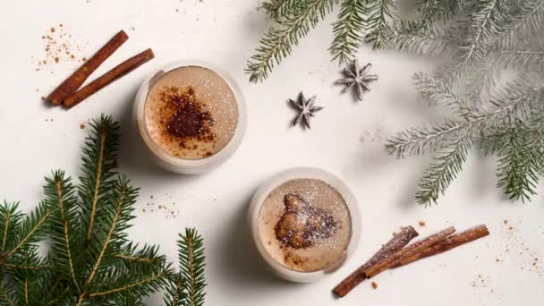 Powder pours on composition like snow. Eggnog is a traditional winter cocktail. — Stock Video