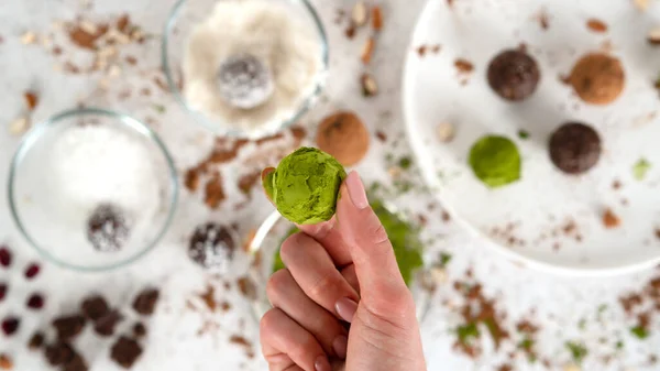 Step by step cooking Energy balls. Step 12 recipe of no bake energy balls. Homemade raw vegetarian fitness dessert covered by matcha tea powder. Healthy eating. Candy making process. Selective focus.