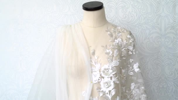 Wedding dress tailoring. Woman sewing mannequin and lace fabric. The dummy turns — Stock Video